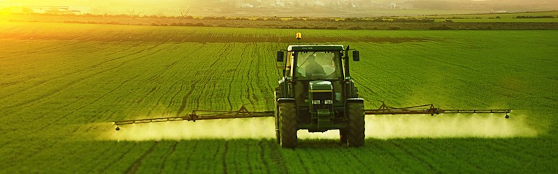 Tractor spraying crops